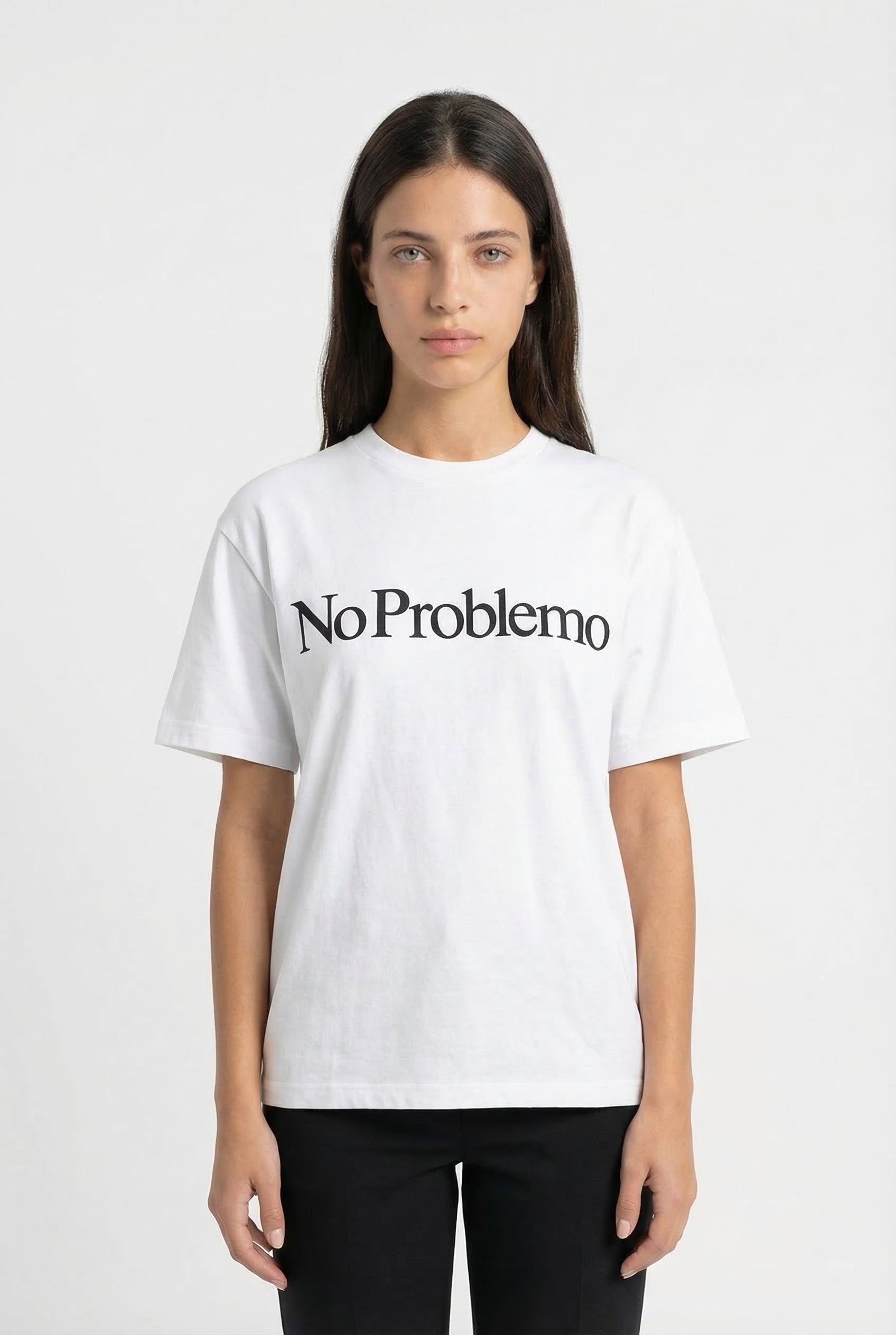 Person wearing a white t-shirt with 'No Problemo' text on a plain background